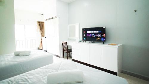 Postel nebo postele na pokoji v ubytování PT Grand Hotel