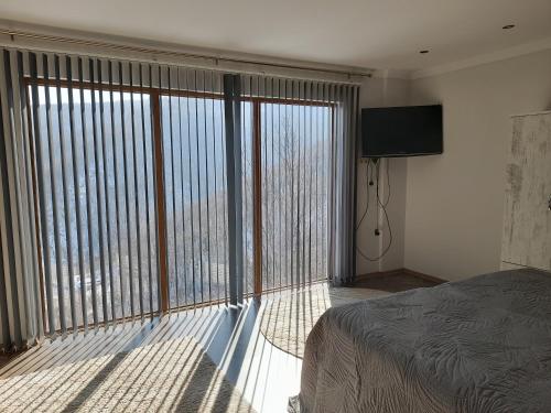 a bedroom with a bed and a large window at Turkish Retreat in Saadet