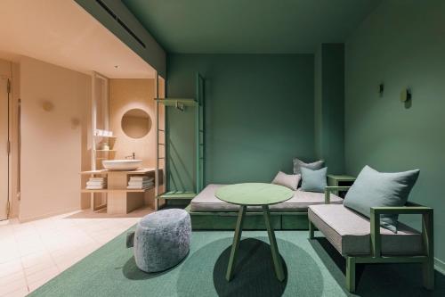 a room with a bed and a table and a chair at toggle hotel suidobashi TOKYO in Tokyo