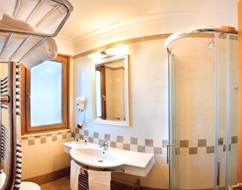 a bathroom with a sink and a shower at Comfort Hotel Gardenia Sorrento Coast in Sorrento