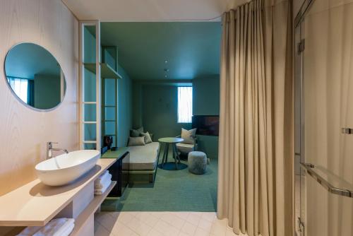 a bathroom with a sink and a toilet in a room at toggle hotel suidobashi TOKYO in Tokyo