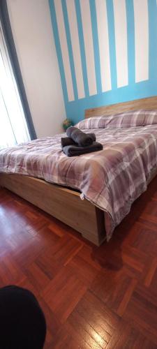 a bed sitting in a room with a wooden floor at La tesoriera in Turin