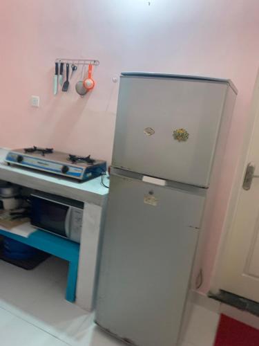 a refrigerator in a kitchen next to a counter at Araliya Suite in Nugegoda