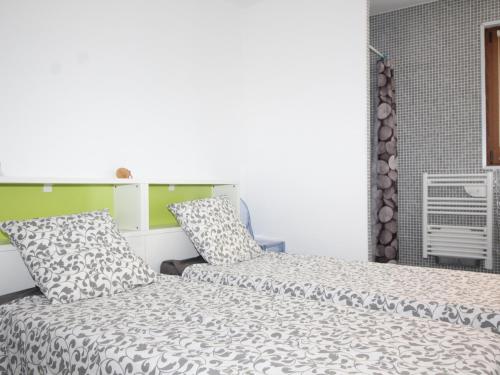 a bedroom with two beds and a window at Appartement rénové au centre de Collioure avec terrasse, parking, clim portative et Wi-Fi - FR-1-309-190 in Collioure