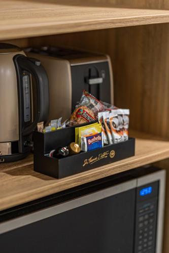a shelf with a box of snacks next to a microwave at Seahaven Resort in Townsville