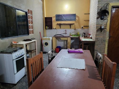 a kitchen with a table and a stove and a sink at El Hostal de Lucy in Luque