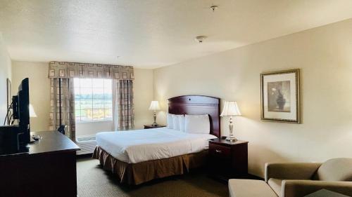 a hotel room with a bed and a window at Franklin Inn & Suites in Franklin