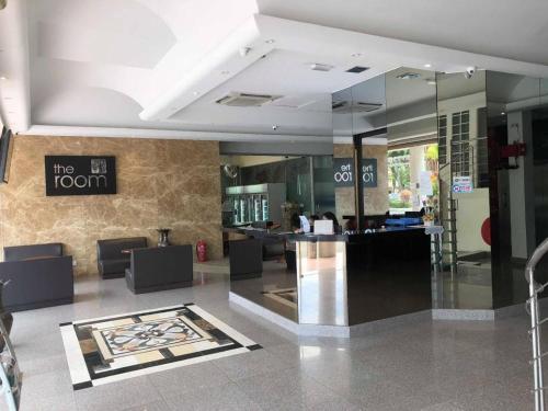 a lobby with a bar in the middle of a building at The Room Hotel in Miri