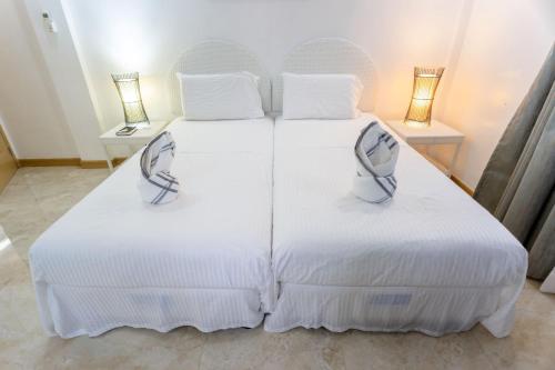 Кровать или кровати в номере MADISON GARDEN AND RESIDENCES