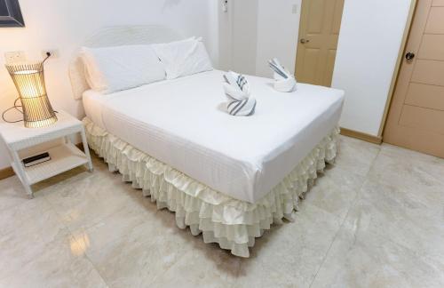 Кровать или кровати в номере MADISON GARDEN AND RESIDENCES