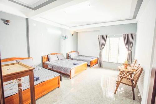a living room with two beds and a piano at Homestay Nhà Muội in Quy Nhon
