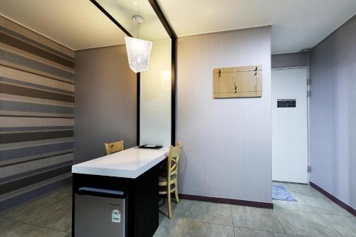 a room with a white counter and a door at White Tourist Hotel in Jeonju