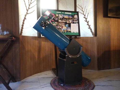 a blue water slide in a room with a television at Astroport Sariska Treetop by Eight Continents in Tehla