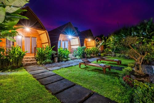 a house with a garden at night at KINTAMANI Paradise Villa in Kintamani