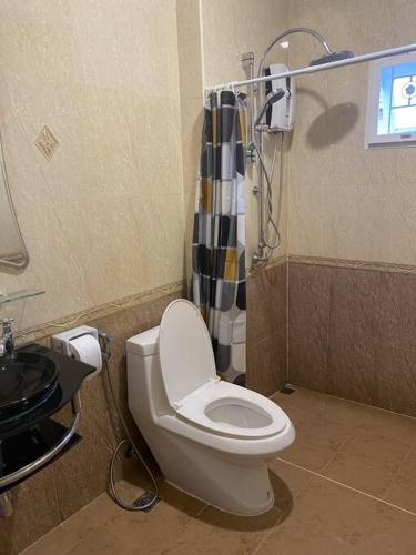 a bathroom with a toilet and a shower at Let's Chill Pool Villa Pattaya Najomtien42 and Sattahip in Ban Tao Than