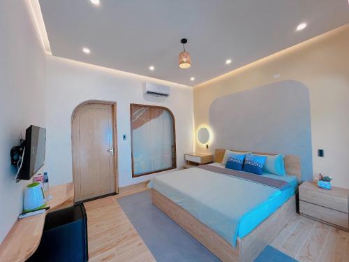 a bedroom with a bed and a flat screen tv at Sea House Hotels and Apartments in Vung Tau