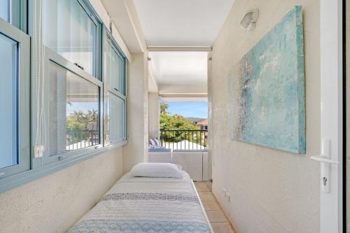 two beds in a room with a window at The Masthead Iluka Apartment Luxury and Style in Palm Beach