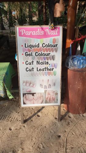 a sign in the sand in front of a store at Paradis Villa B3 in Ko Kho Khao