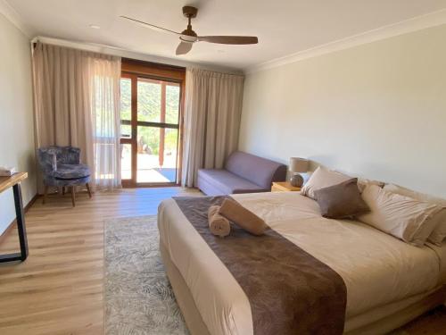 a bedroom with a bed and a couch and a chair at Arkaroola Wilderness Sanctuary in Arkaroola