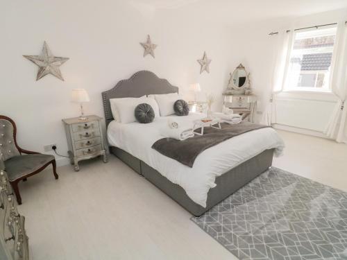 a bedroom with a large bed with stars on the wall at Blacksmiths Cottage in Alnwick
