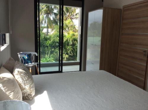 a bedroom with a bed and a large window at 65/66 South Beach Apartment in Blue Bay