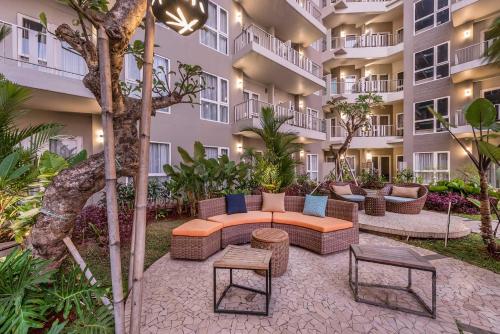 an outdoor patio with furniture in a apartment building at Grande Valore Hotel Cikarang in Cikarang