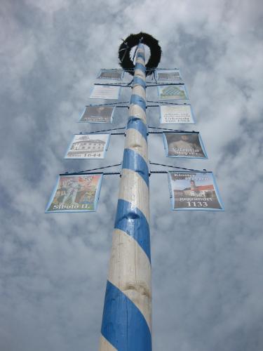 a blue and white pole with signs on it at Hotel Alter Wirt in Weyarn