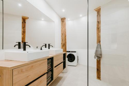 a bathroom with a sink and a washing machine at Luxury 2BR Apartment in Haapsalu Old Town in Haapsalu