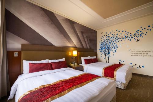 a hotel room with two beds with red and white at Golden Tulip - Aesthetics in Zhunan