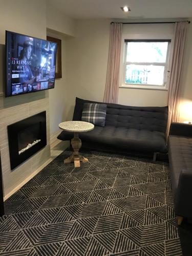 a living room with a couch and a fireplace at Lovely Downtown House +2 parking in Toronto