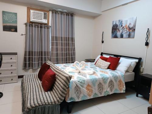 a bedroom with a bed and a chair in it at MS PASAY HOMESTAY 101 NEWPORT BLVD - Airport NAIA T3 near SAVOY BELMONT 300MBPS NETFLIX in Manila
