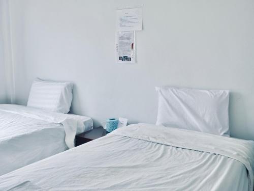 two beds sitting next to each other in a room at C-Code Resort in Wat Pa