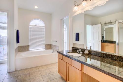 a bathroom with a tub and a sink and a shower at Downtown Houston Townhome with City Views! in Houston