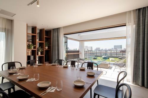 a dining room with a table and chairs and a large window at Tokyu Stay Shinjuku Eastside in Tokyo