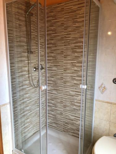 a shower with a glass door in a bathroom at Casa di Taty - Home resort in Policoro