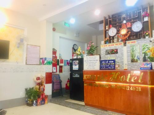 a restaurant with a hotel with clocks on the wall at Kinh Bac Hotel Quy Nhon in Quy Nhon