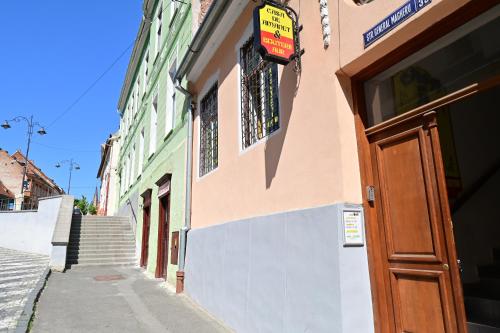 a building with a door on the side of a street at Apartament cu 2 dormitoare, Benjamin Residence, Piata Mare in Sibiu