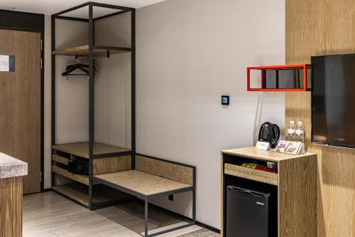 a room with a shelf in the corner of a kitchen at Hsin Hotel in Chiayi City