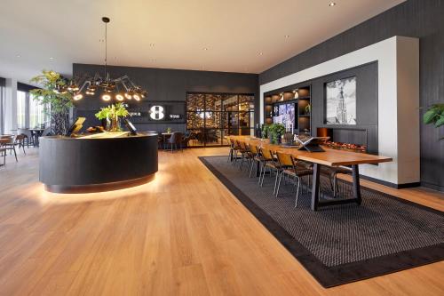 a lobby with a table and chairs and a bar at Gr8 Hotel Breda in Breda