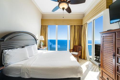 a bedroom with a bed with a view of the ocean at Caribbean Resort 1802 in Navarre