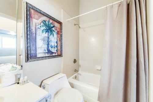 a bathroom with a toilet and a bath tub at Caribbean Resort 1802 in Navarre