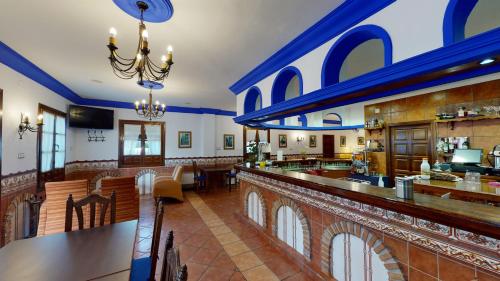 a large room with a bar in a restaurant at Huerta de las Palomas in Priego de Córdoba