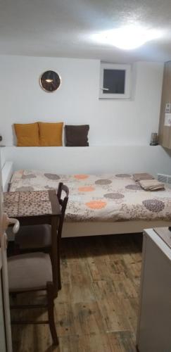 a small room with a bed and a table at Petkovic Apartmani 3 in Tivat