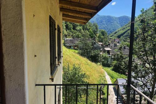 a balcony of a building with a view of a mountain at Spitzenhaus Val Onsernone - Happy Rentals in Vergeletto