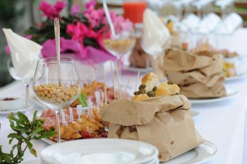 a table with plates of food and a glass of wine at Locanda ai Capitelli snc di fiumicetti andrea in Soave