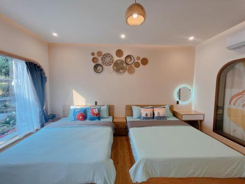 a bedroom with two beds and a window at Sea House Hotels and Apartments in Vung Tau