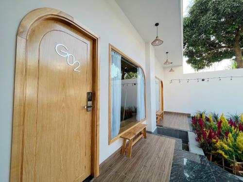 a wooden door in a building with a window at Sea House Hotels and Apartments in Vung Tau