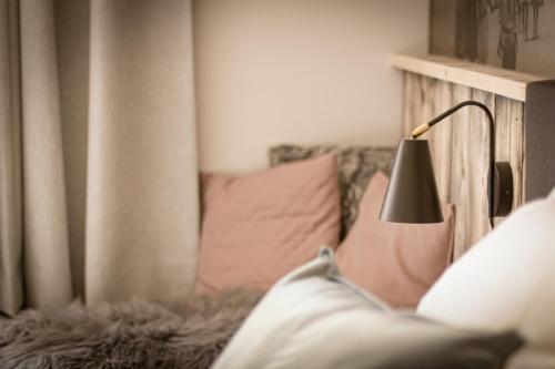 a person sitting on a couch with a lamp at Vins de Dagne in Montlaur