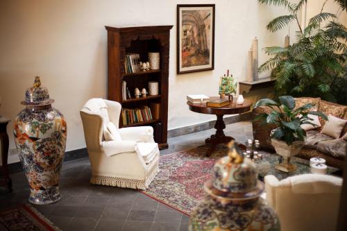 a living room with a couch and chairs and a table at Palazzo Marziale in Sorrento