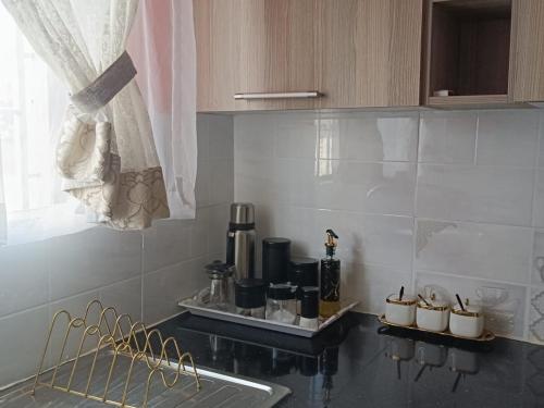 a kitchen with a counter with a sink and a window at BELLS TRIAD - FREE TRANSPORT FROM AIRPORT FOR PRE PAYMENT BOOKINGs in Nairobi